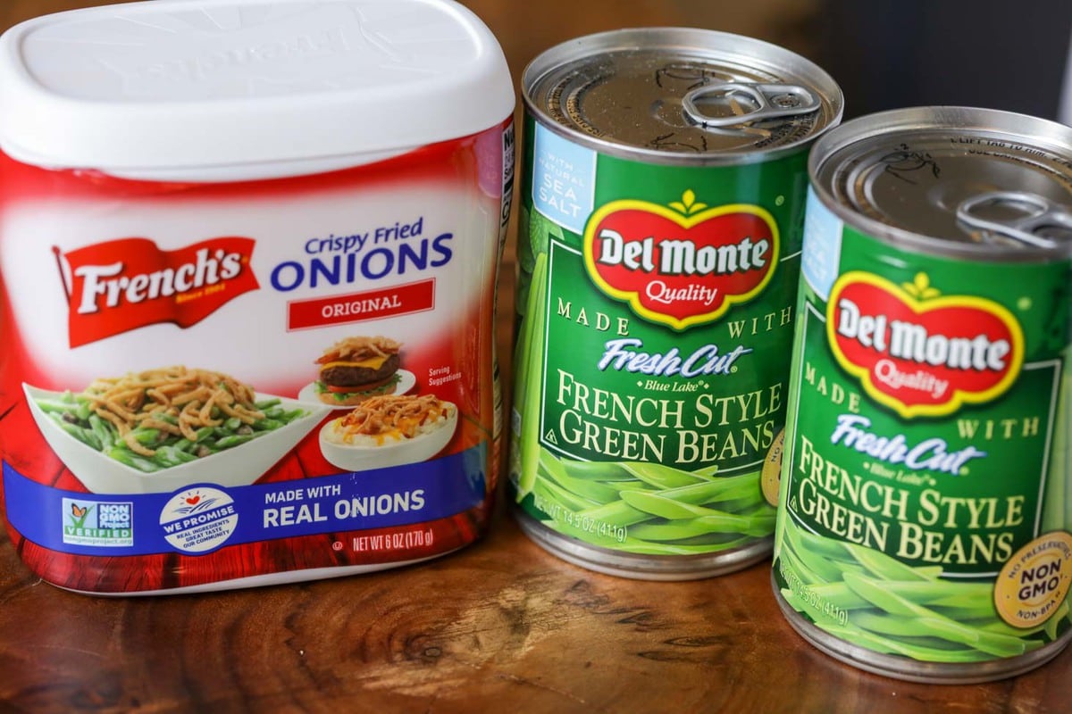 Container of French's Crispy Fried Onions next to two cans of green beans