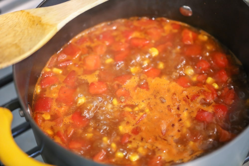 Hamburger soup with vegetables cooking in a pot.