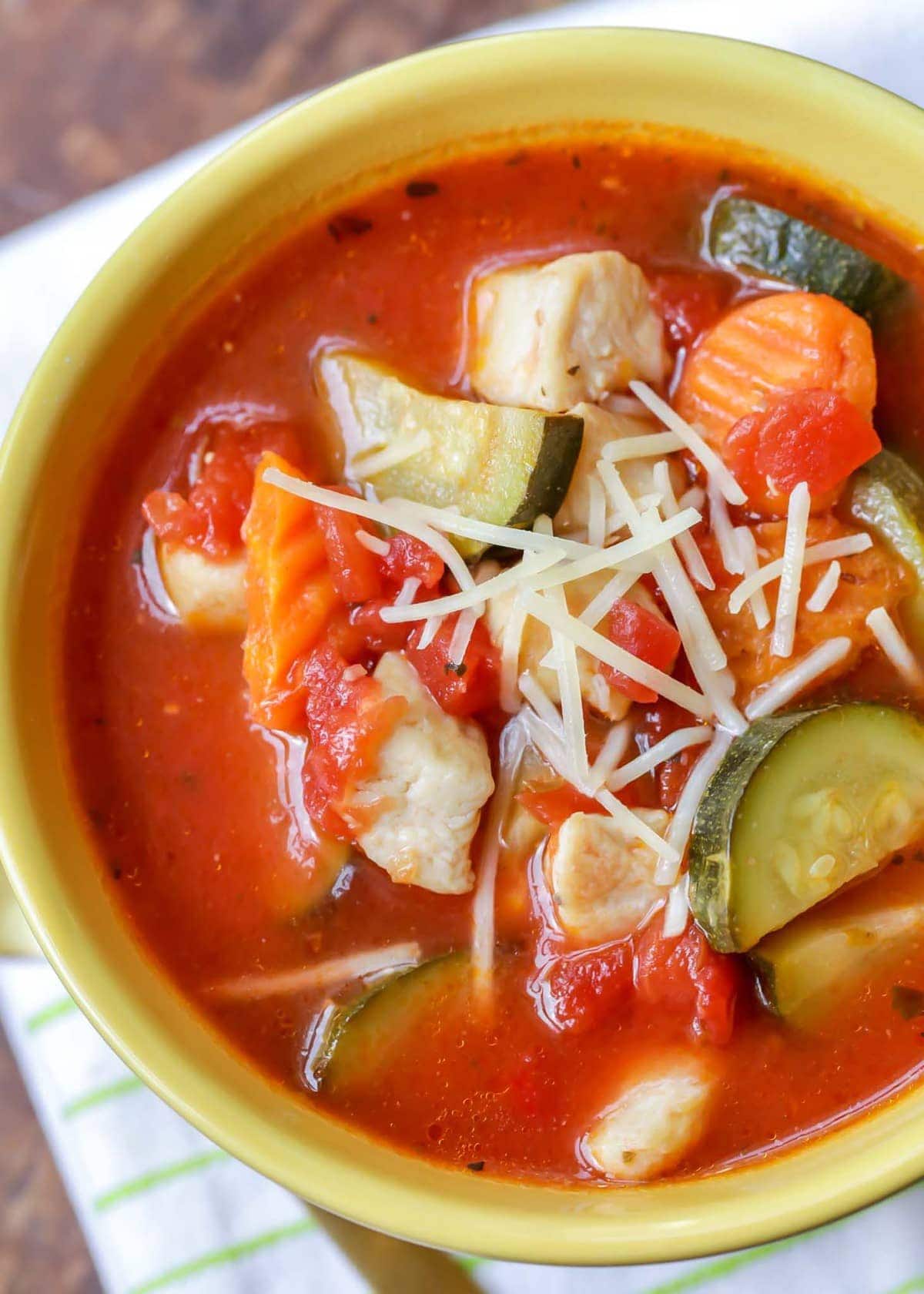 Italian Chicken vegetable Soup topped with parmesan cheese.
