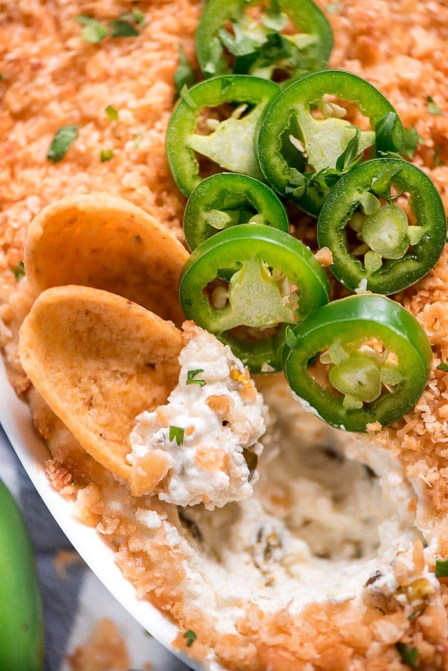 Close up of Jalapeno Popper Dip Recipe topped with fresh jalapenos.