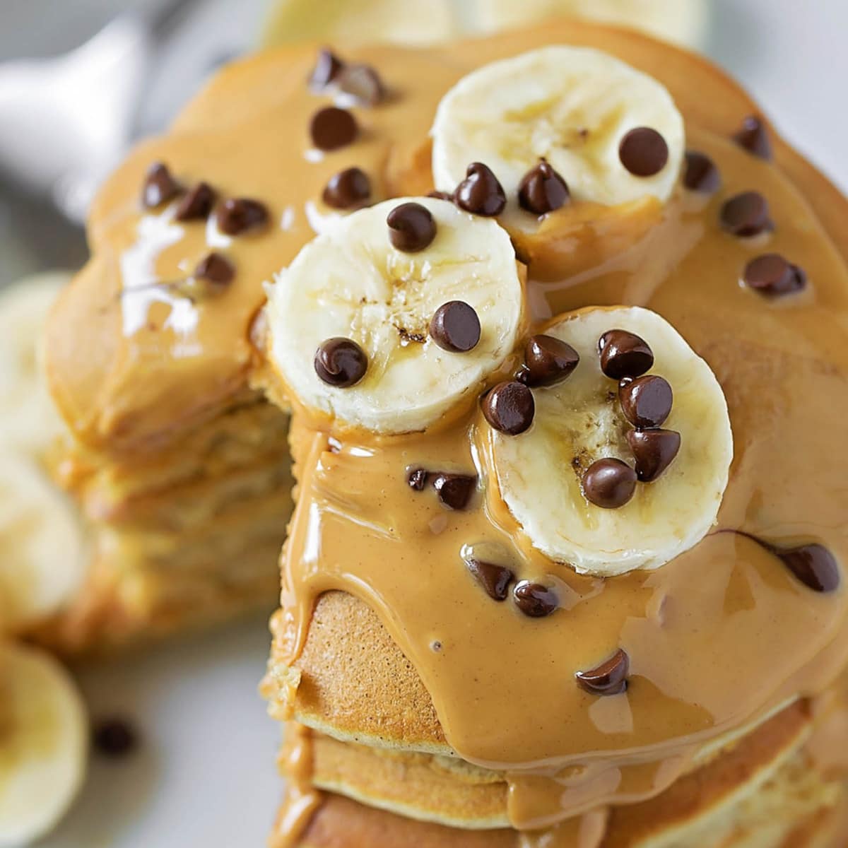 Peanut Butter Banana Pancakes topped with sliced bananas