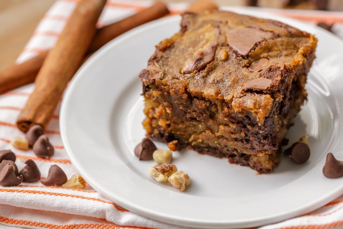 Thanksgiving dinner ideas - a square slice of pumpkin brownies on a white plate.