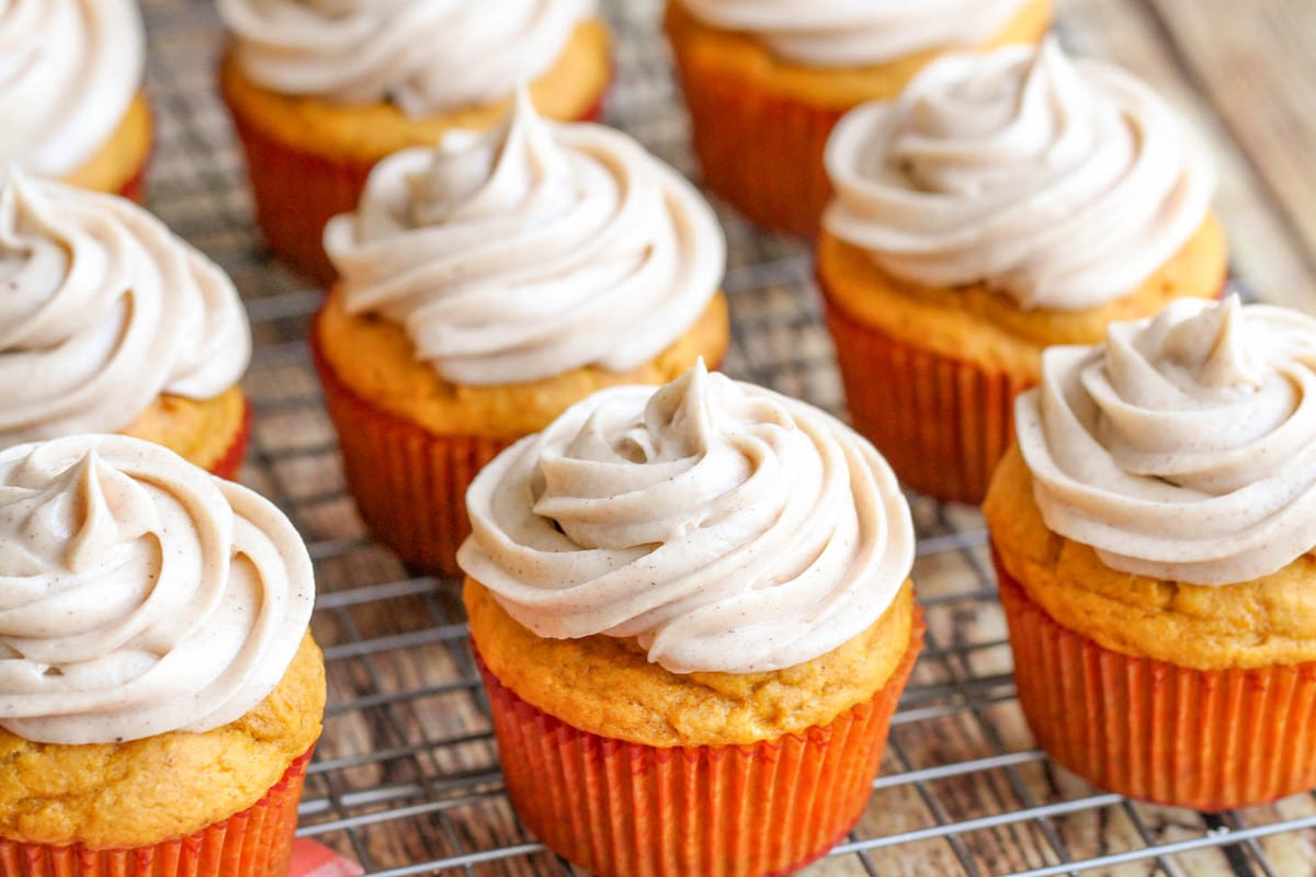 Pumpkin Cupcakes with Cream Cheese Frosting on a wire rack