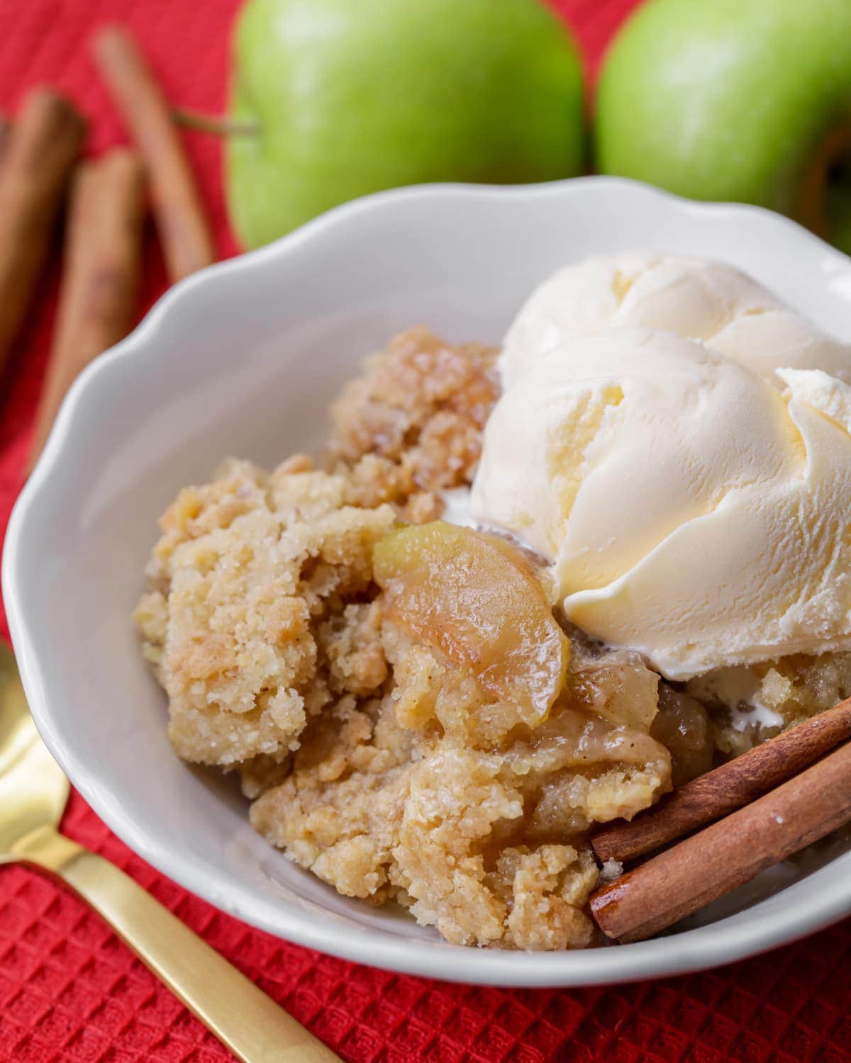 Blueberry cobbler - a bowl of apple cobbler topped with vanilla ice cream.