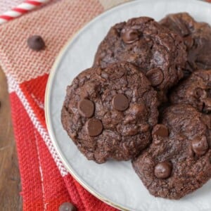 Brownie cookies stacked on a white plate.