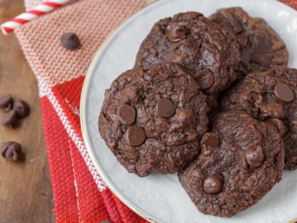 Brownie cookies stacked on a white plate.