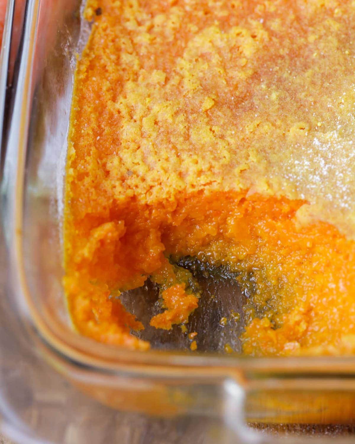 Carrot Souffle in a baking dishing, with a scoop missing