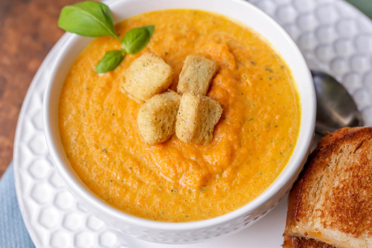 Carrot Soup served in a white bowl with croutons