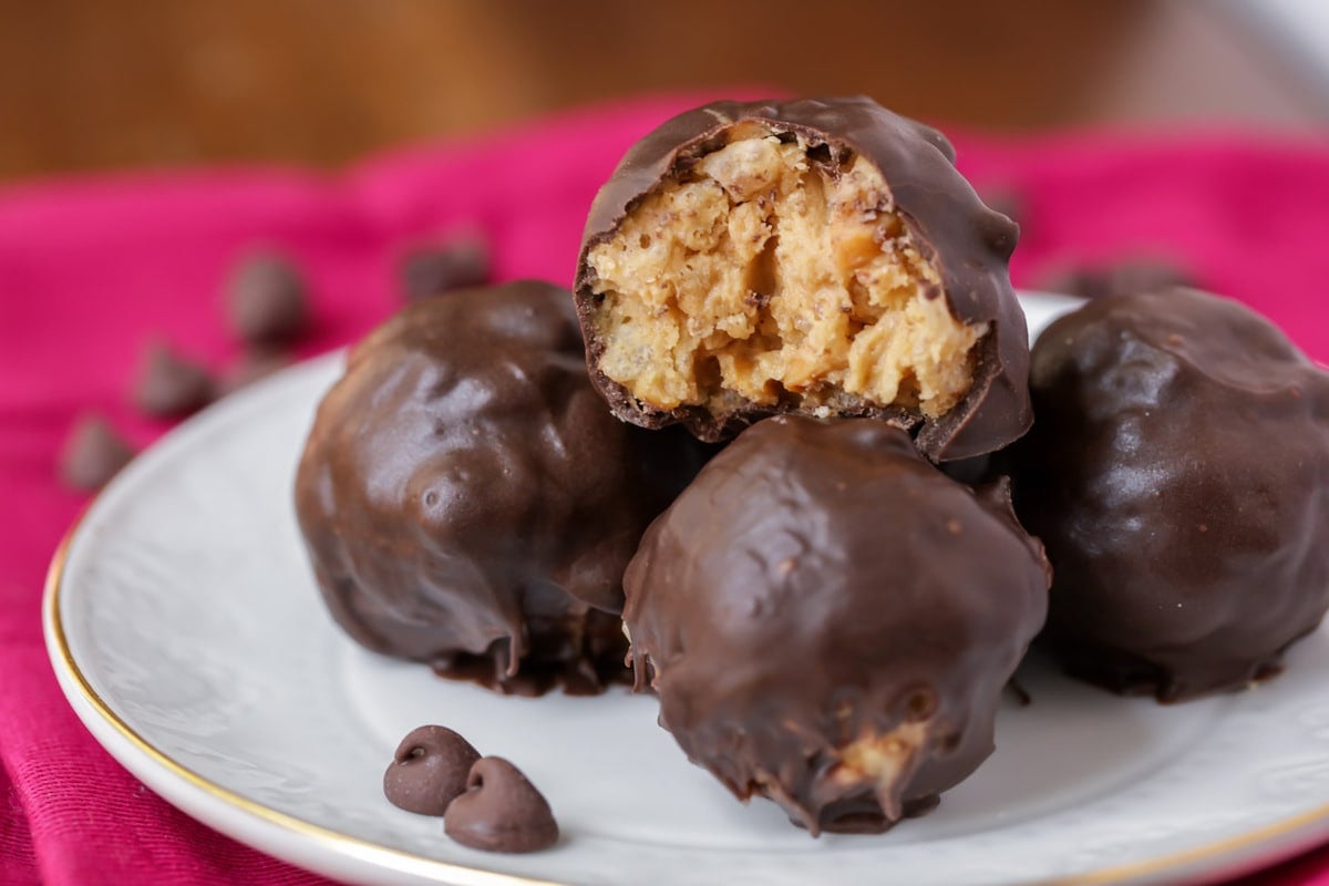 Peanut Butter Rice Crispy Balls stacked on a white plate