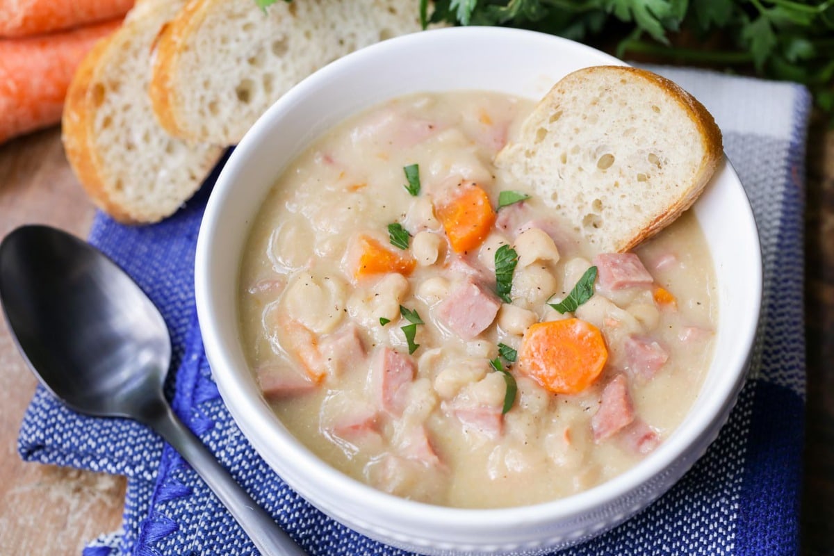 Easy soup recipes - creamy ham and bean soup in a white bowl.