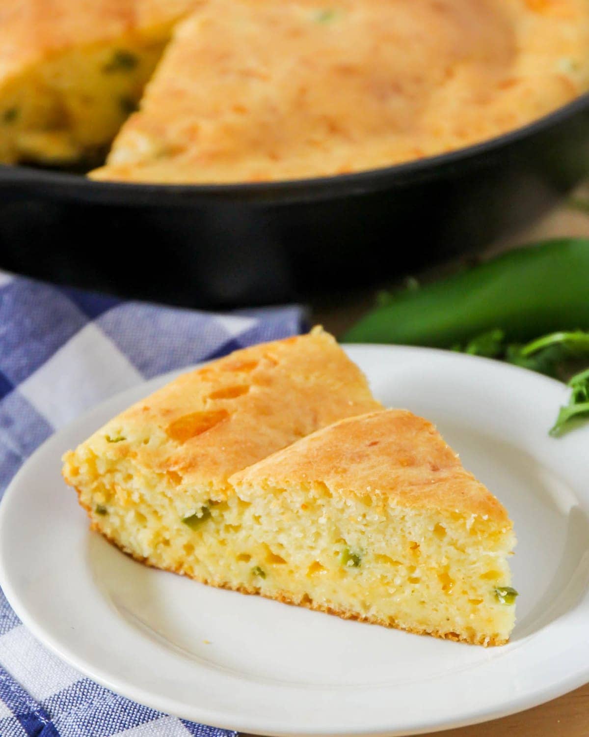 A slice of cheesy Mexican cornbread on a white plate.
