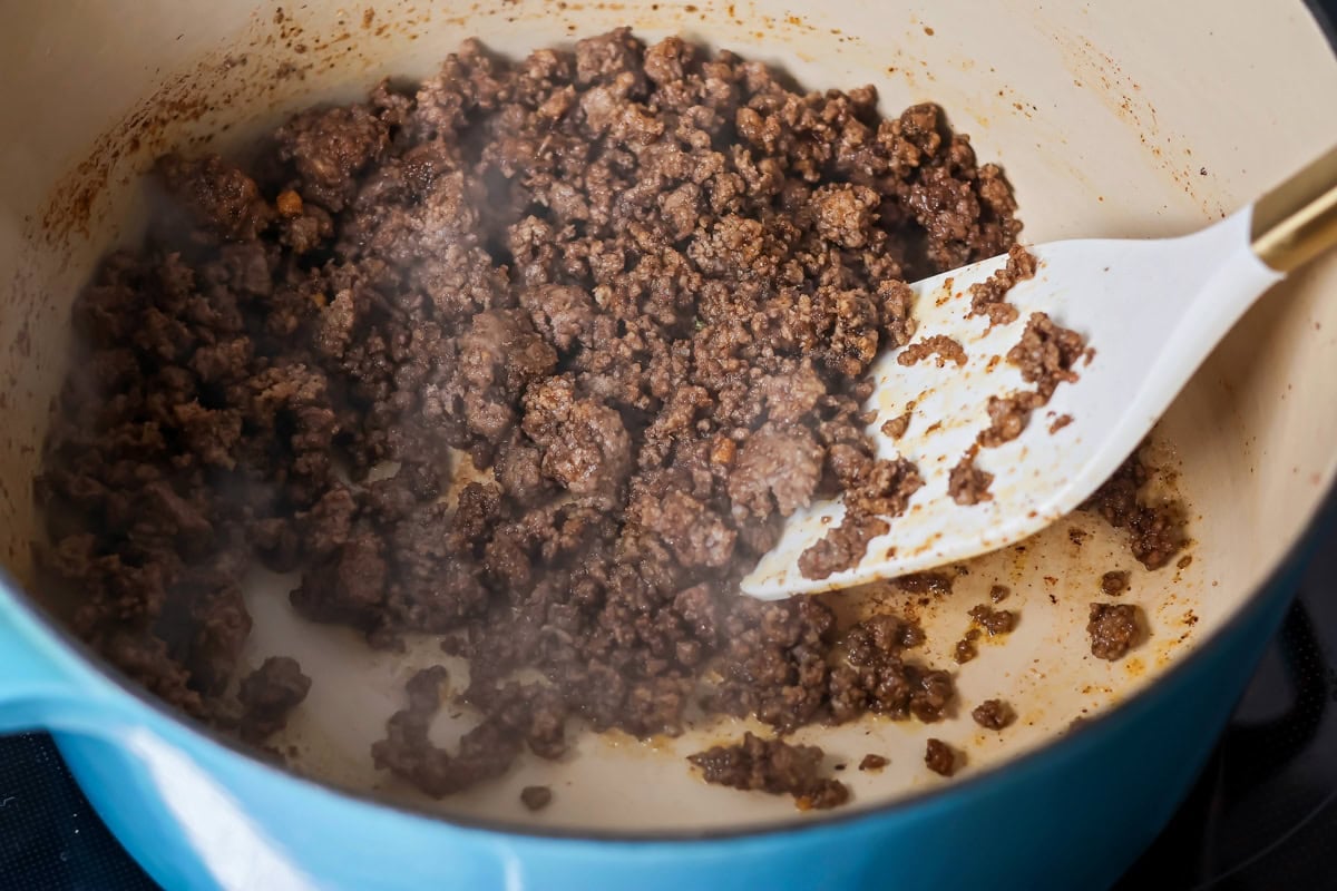 Ground beef being cooked in pot.