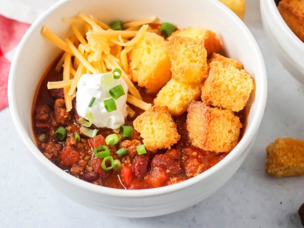 Chili recipe close up image with toppings on top of the chili.