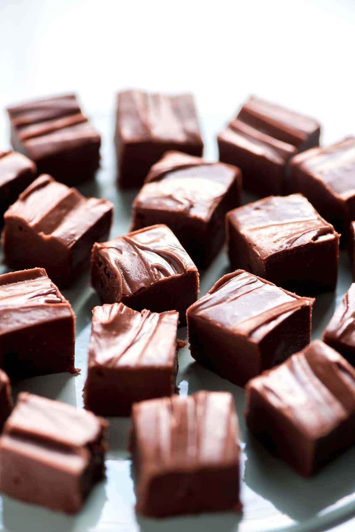 Chocolate Fudge recipe stacked on a plate.