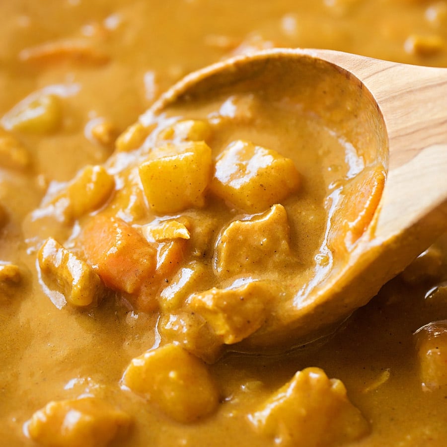Coconut Curry Sauce on a wooden spoon