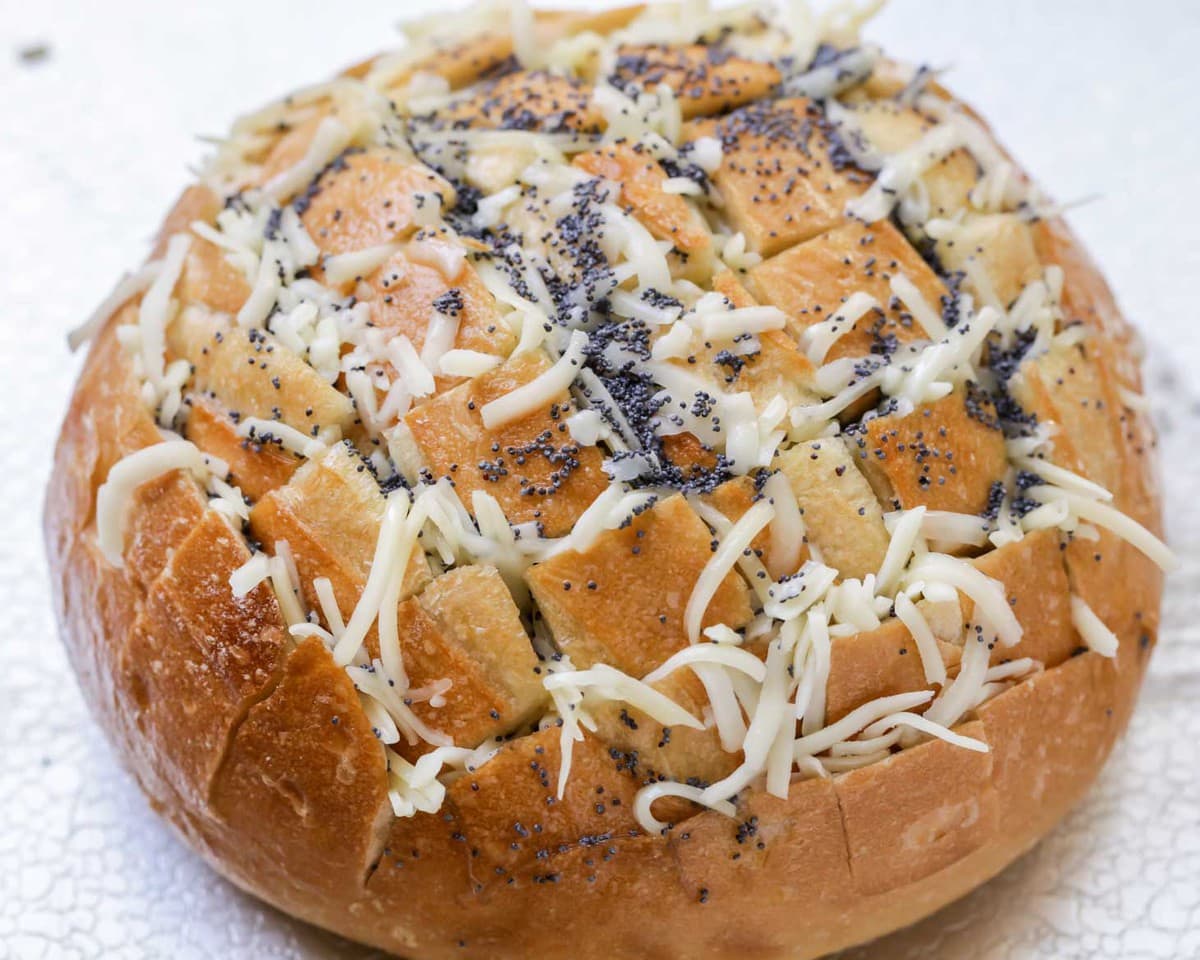 Cheesy Pull Apart Bread topped with poppy seeds ready for baking.