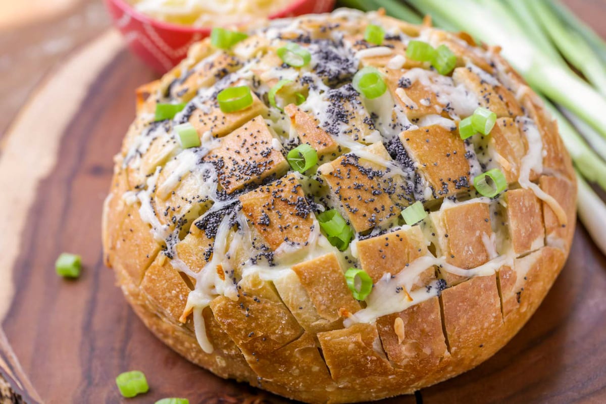 Baked Pull Apart Bread topped with cheese and green onions.
