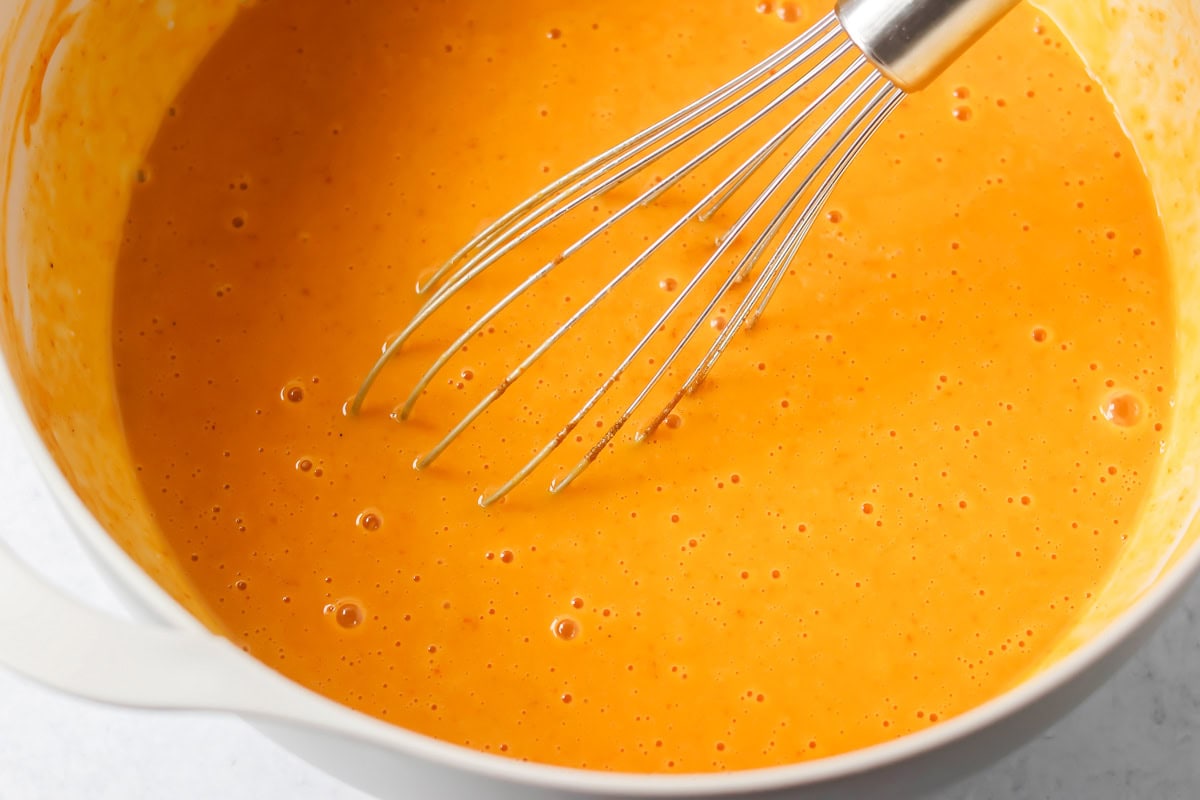 Pumpkin dump cake batter mixed in bowl.