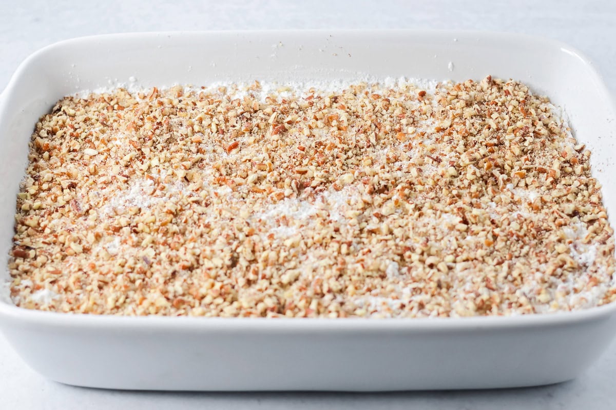 Pecans poured over cake mix batter.