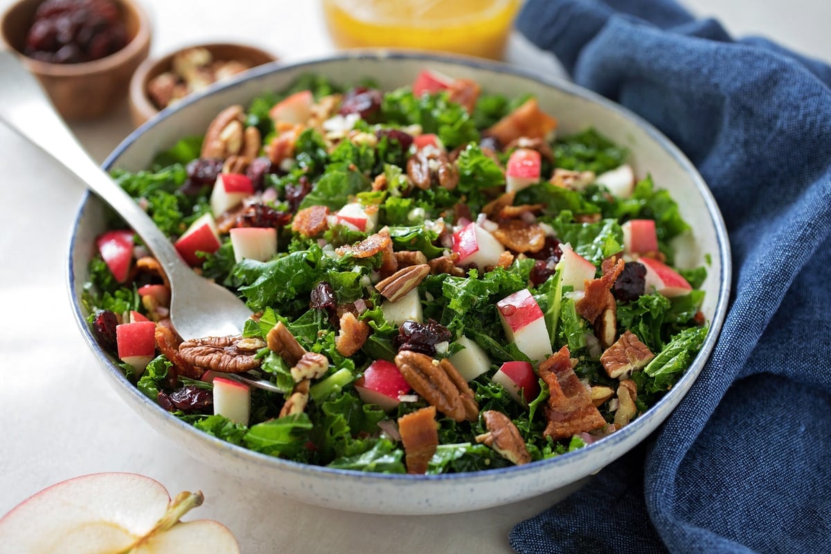 Fall salad recipes - kale salad topped with apples and pecans.