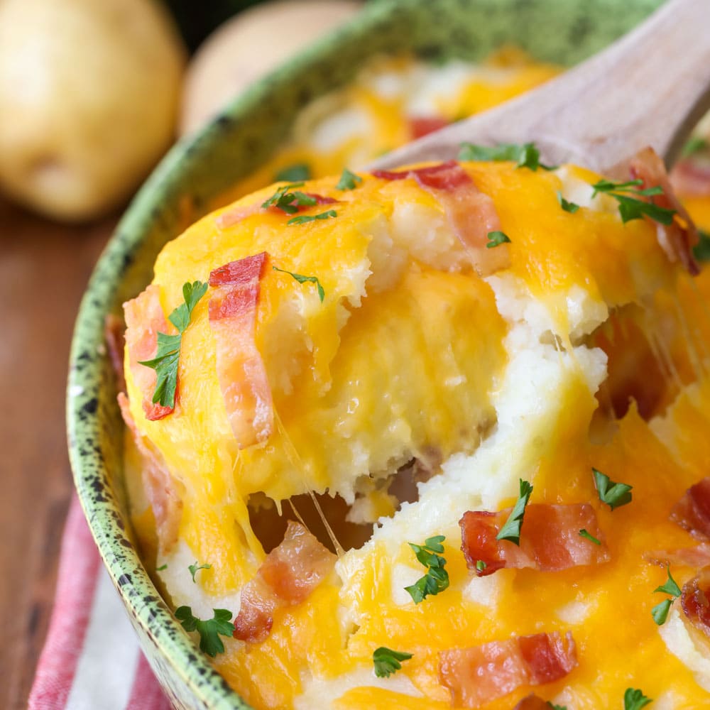 Thanksgiving side dishes - baked mashed potatoes covered in cheese.