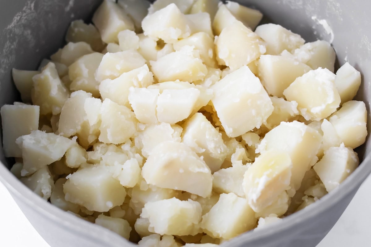 Cooked potatoes in mixing bowl.