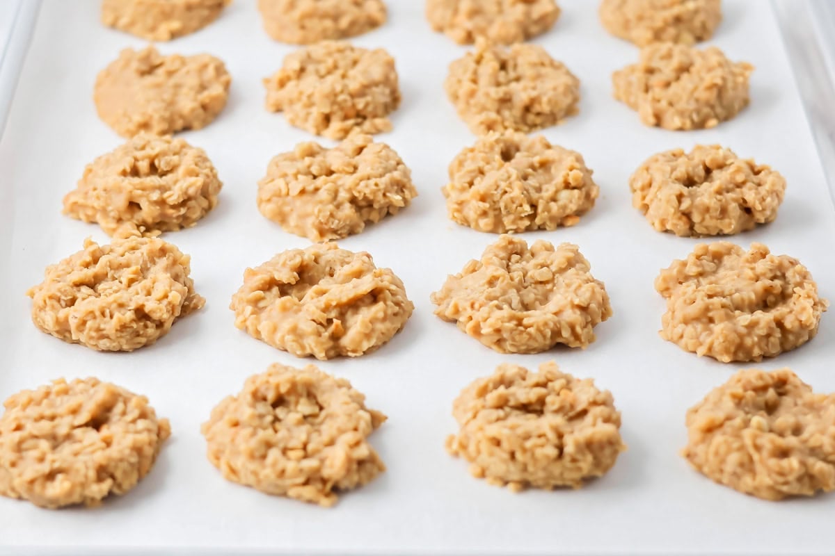 Peanut butter no bake cookies on parchment paper lined cookie sheet.