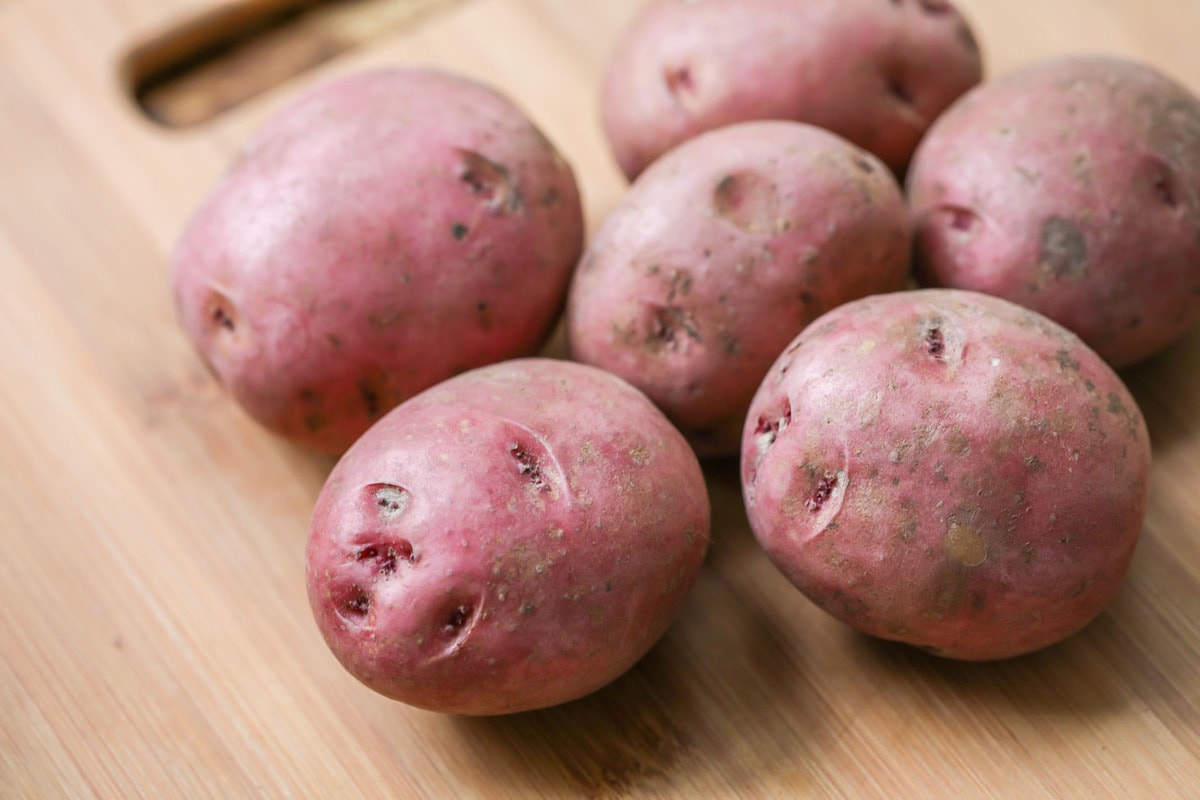 Red potatoes on cutting board for twice baked potatoes casserole