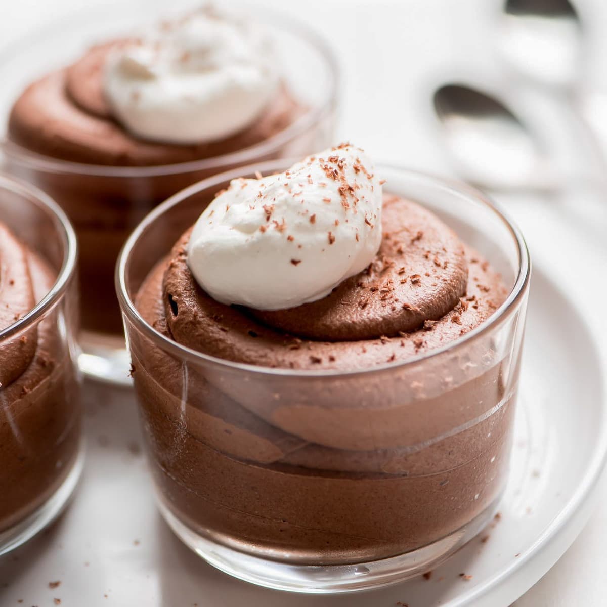 Valentine's Day Desserts - Chocolate Mousse in a clear bowl topped with whipped cream and chocolate shavings. 