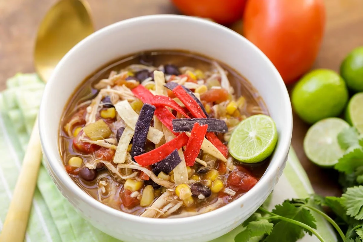 Healthy chicken tortilla soup in a white bowl. 