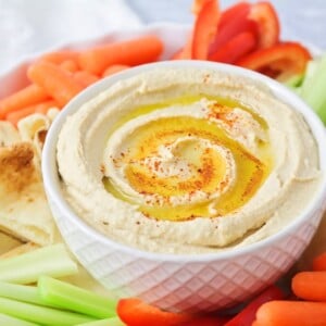 Homemade Hummus recipe is smooth and creamy with tahini, chickpeas, lemon juice, garlic, olive oil, cumin, and salt.