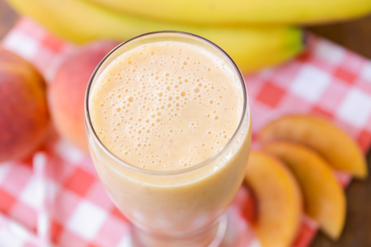 Top view of a Peach Smoothie served in a tall glass.