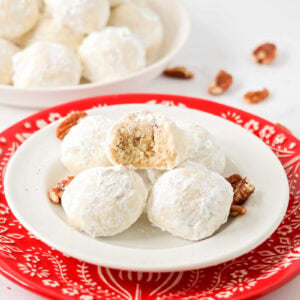 Snowball Cookies on white and red plate.