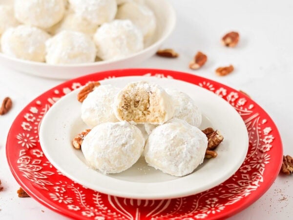 Snowball Cookies on white and red plate.