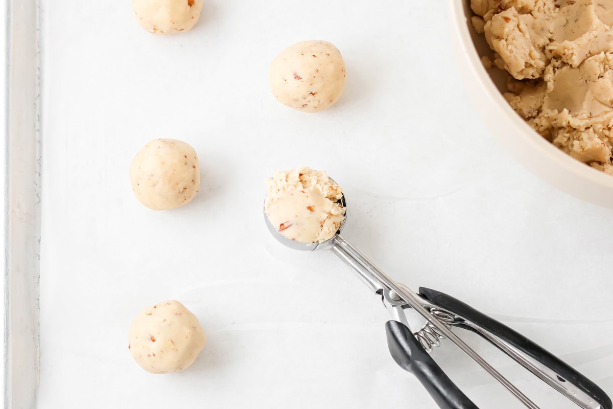 Cookies being scooped with cookie scoop.