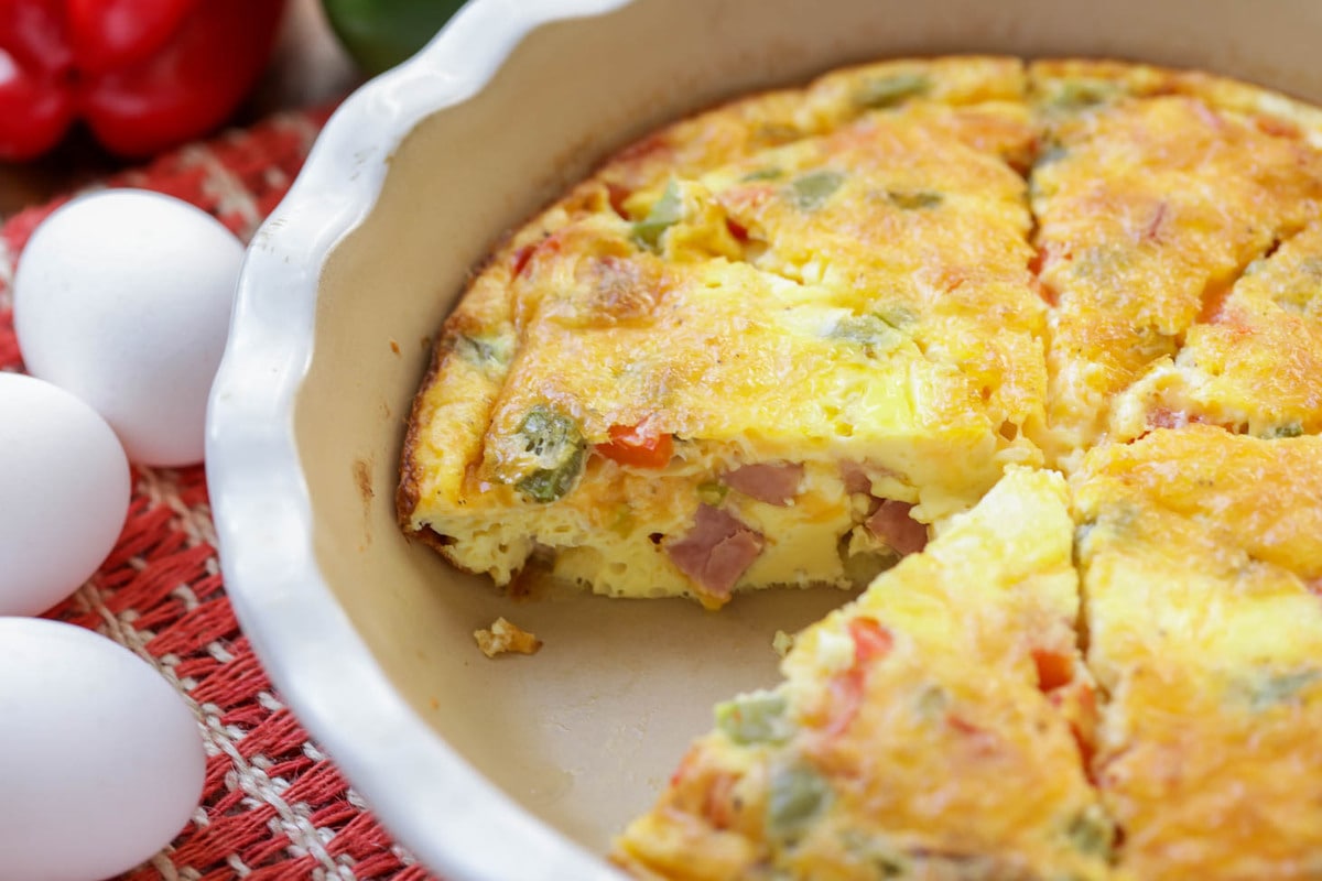 Healthy Denver omelet with ham and vegetables sliced in a baking dish.