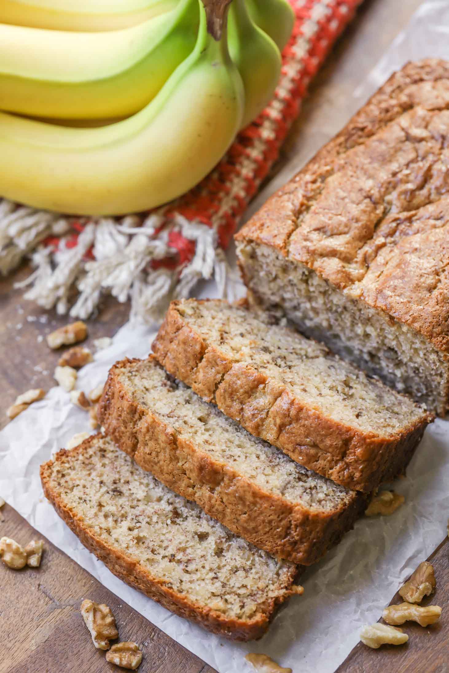 Close up of sliced banana nut bread served with nuts.