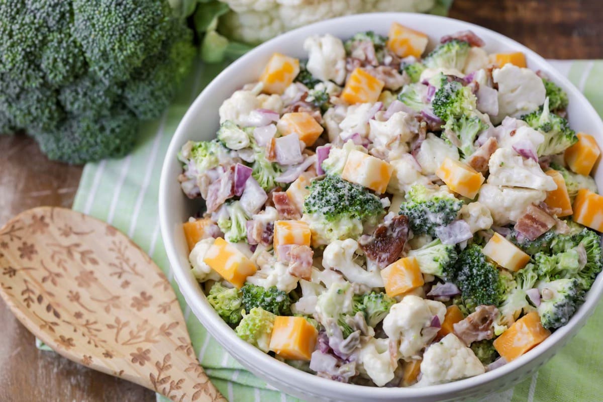 Broccoli Cauliflower Salad served in a white bowl.