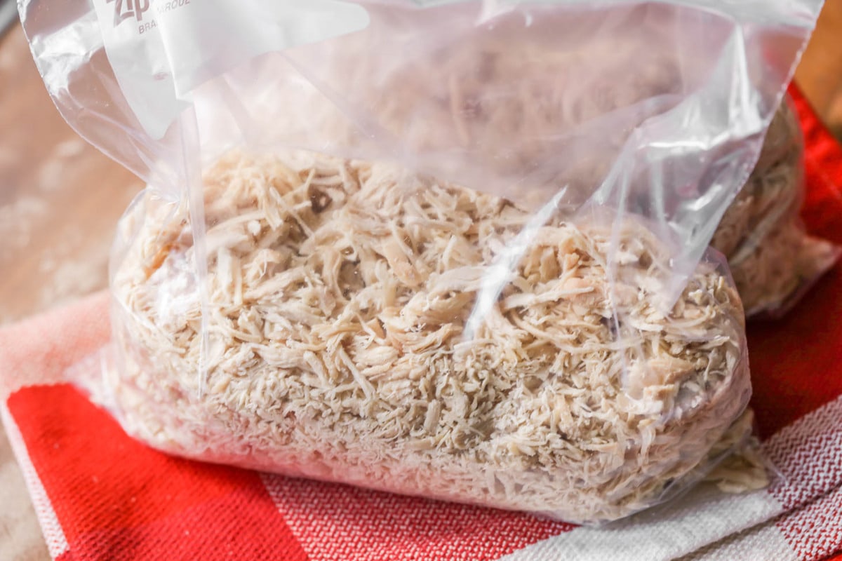 Shredded cooked chicken in a Ziploc bag to freeze.