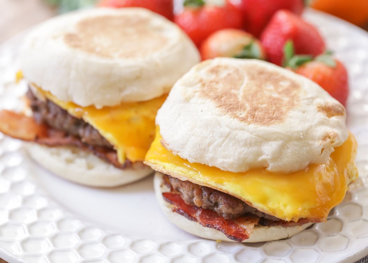 Breakfast for dinner - two breakfast sandwiches served with strawberries.