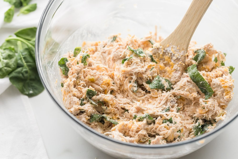 Chicken mixture with cream cheese and spinach in a bowl.