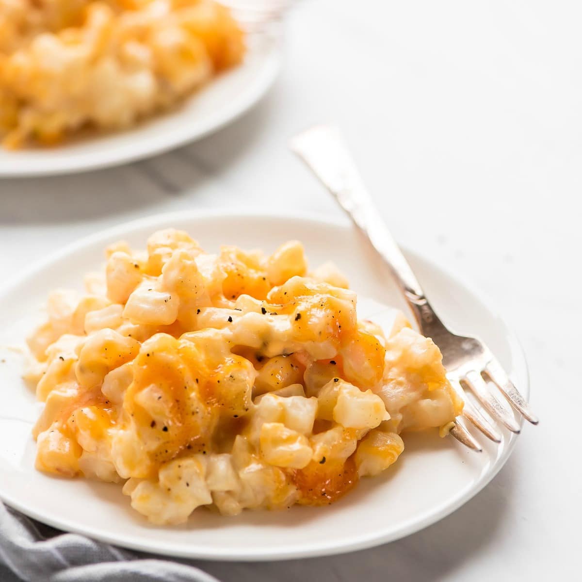 Easy side dishes - crockpot cheesy potatoes piled on a plate.