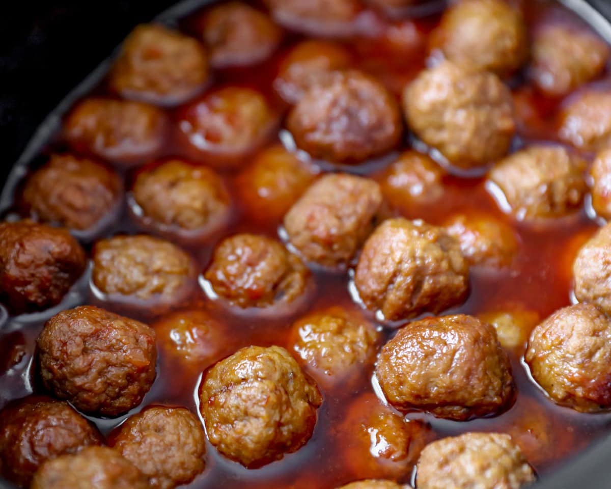 Crockpot meatballs recipe in slow cooker heating up.