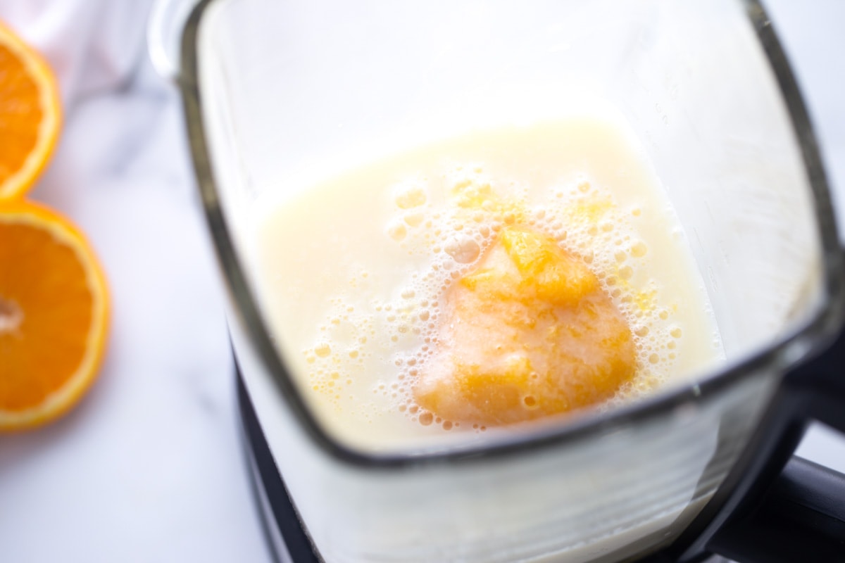 Orange Julius ingredients in a blender.