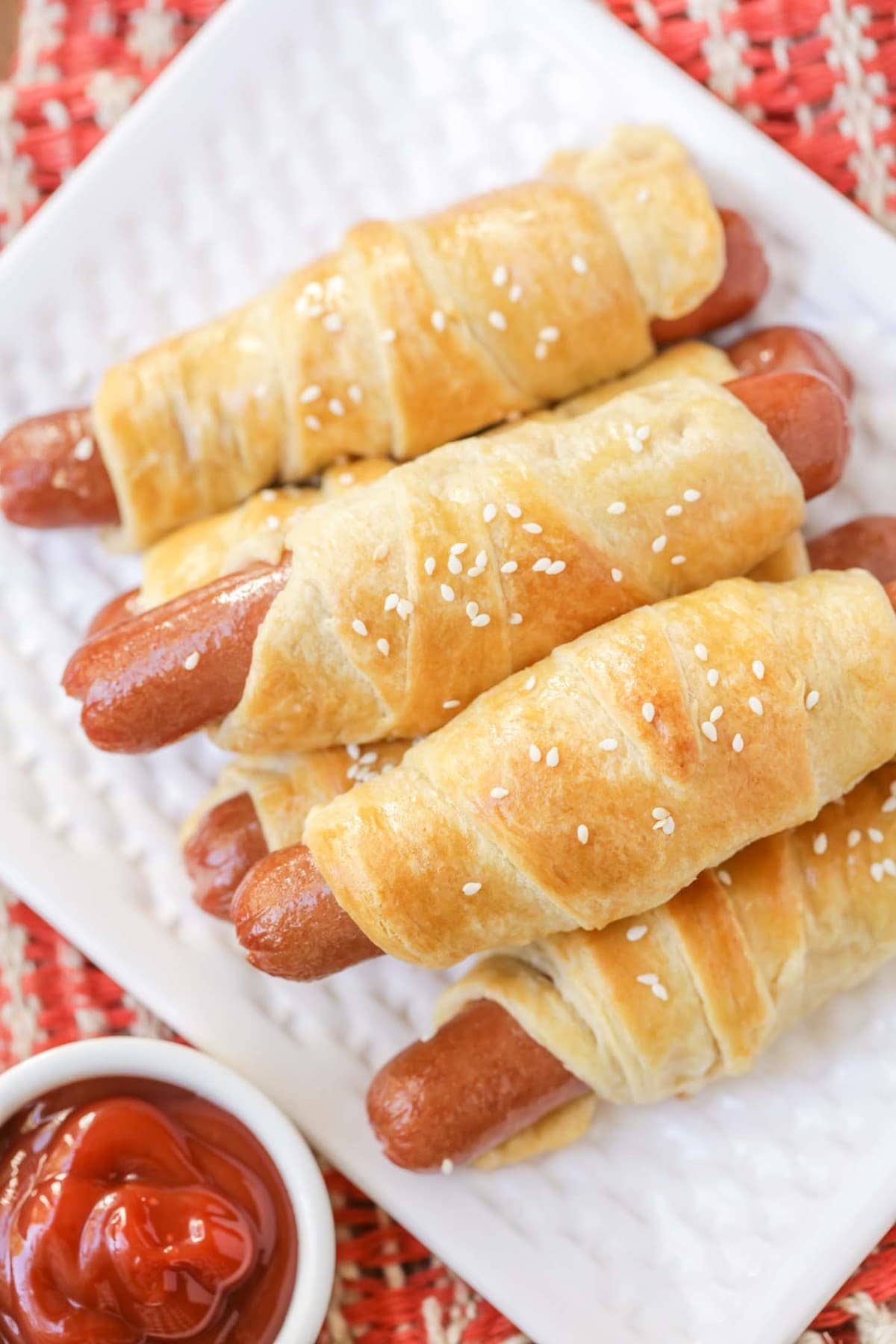 Easy Pigs in a Blanket Recipe - hero shot on white dish with ketchup