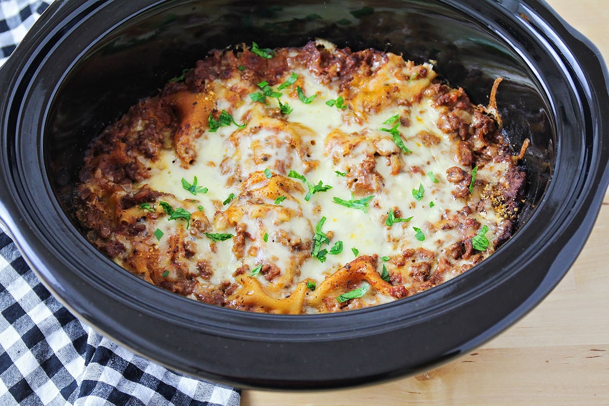 Pasta, meat sauce, and cheese layered and cooked in a crock pot.