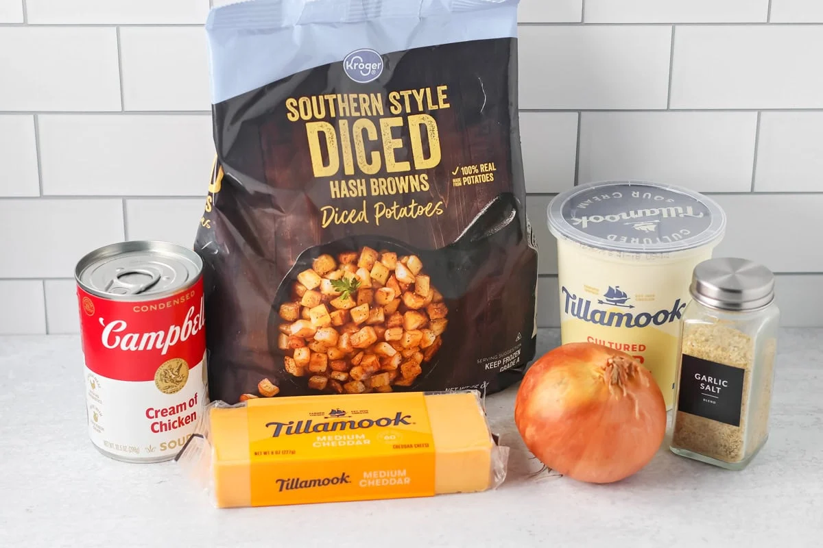 Crockpot cheesy potatoes ingredients on counter.