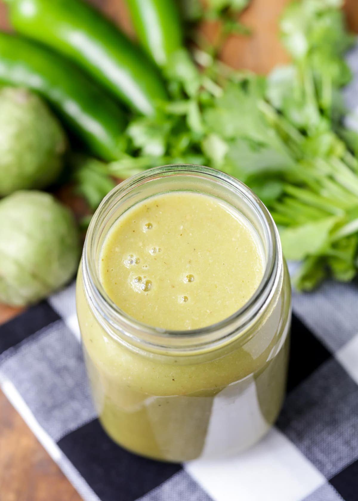 Homemade green enchilada sauce in jar close up image.