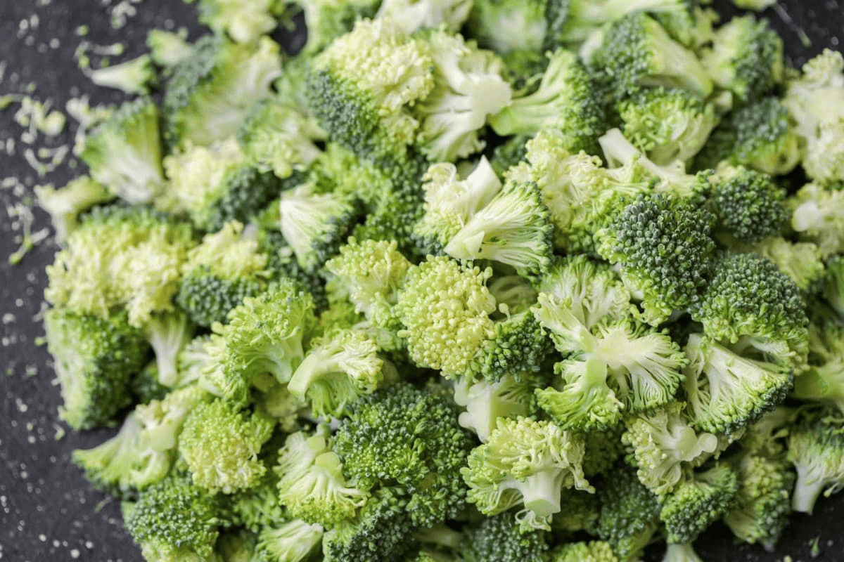 Chopped broccoli on cutting board.