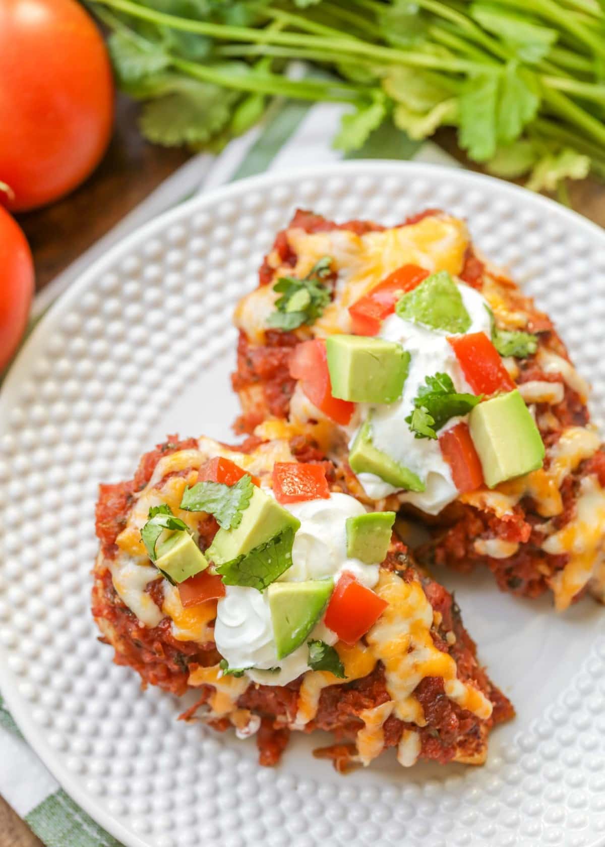 Two salsa chicken breasts on a white plate